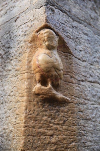 The Dijon owl, worn smooth by centuries of rubbing, barely recognizable in the stone